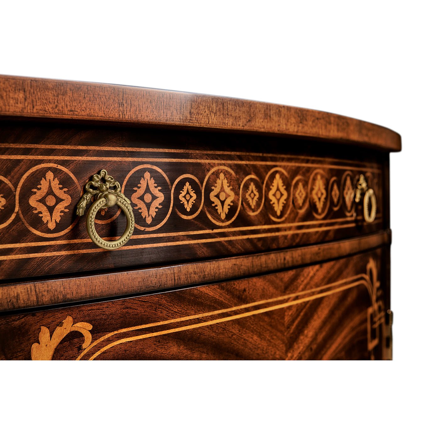 Commode's decorative drawer handles and ornate trim.