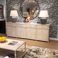 Decorated rustic washed buffet sideboard in living room.