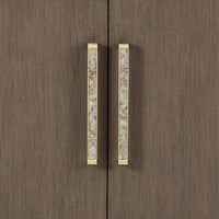 Close-up of ornate handles on sideboard buffet.