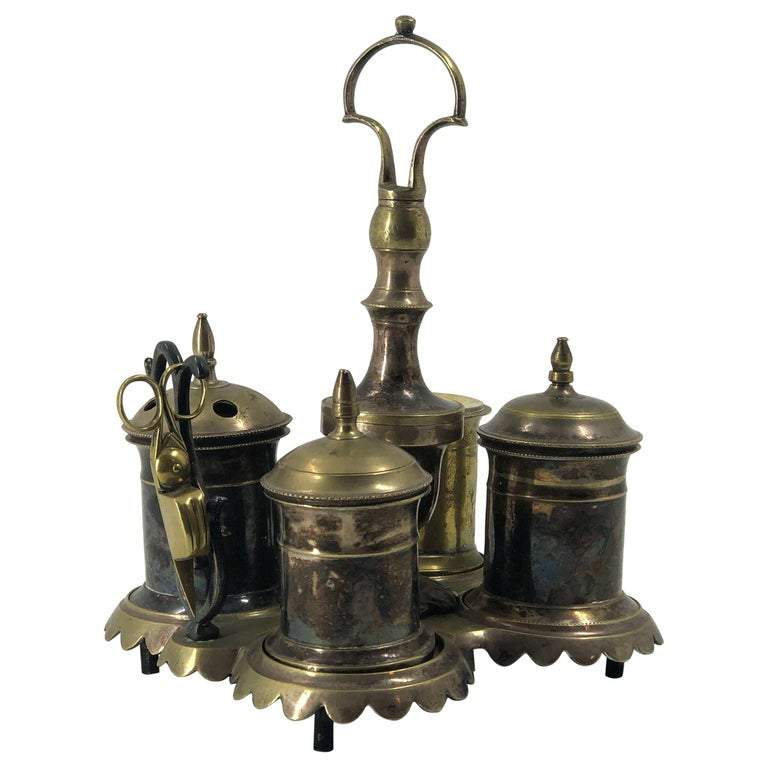 Antique silvered brass standish on display, front view.