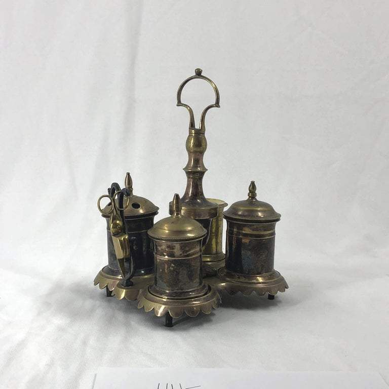 Silvered brass standish with intricate design, side angle.