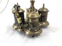 Close-up of silvered brass standish with scissors attached.