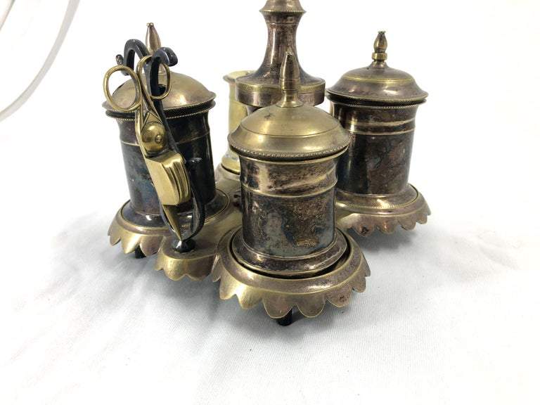 Close-up of silvered brass standish with scissors attached.