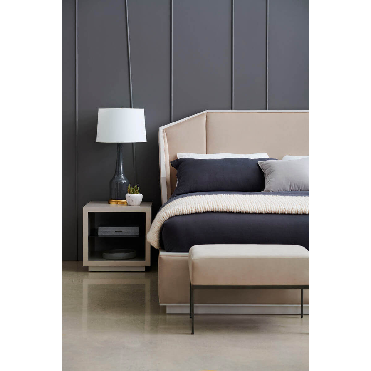 Close-up of bench and bed in modern bedroom.