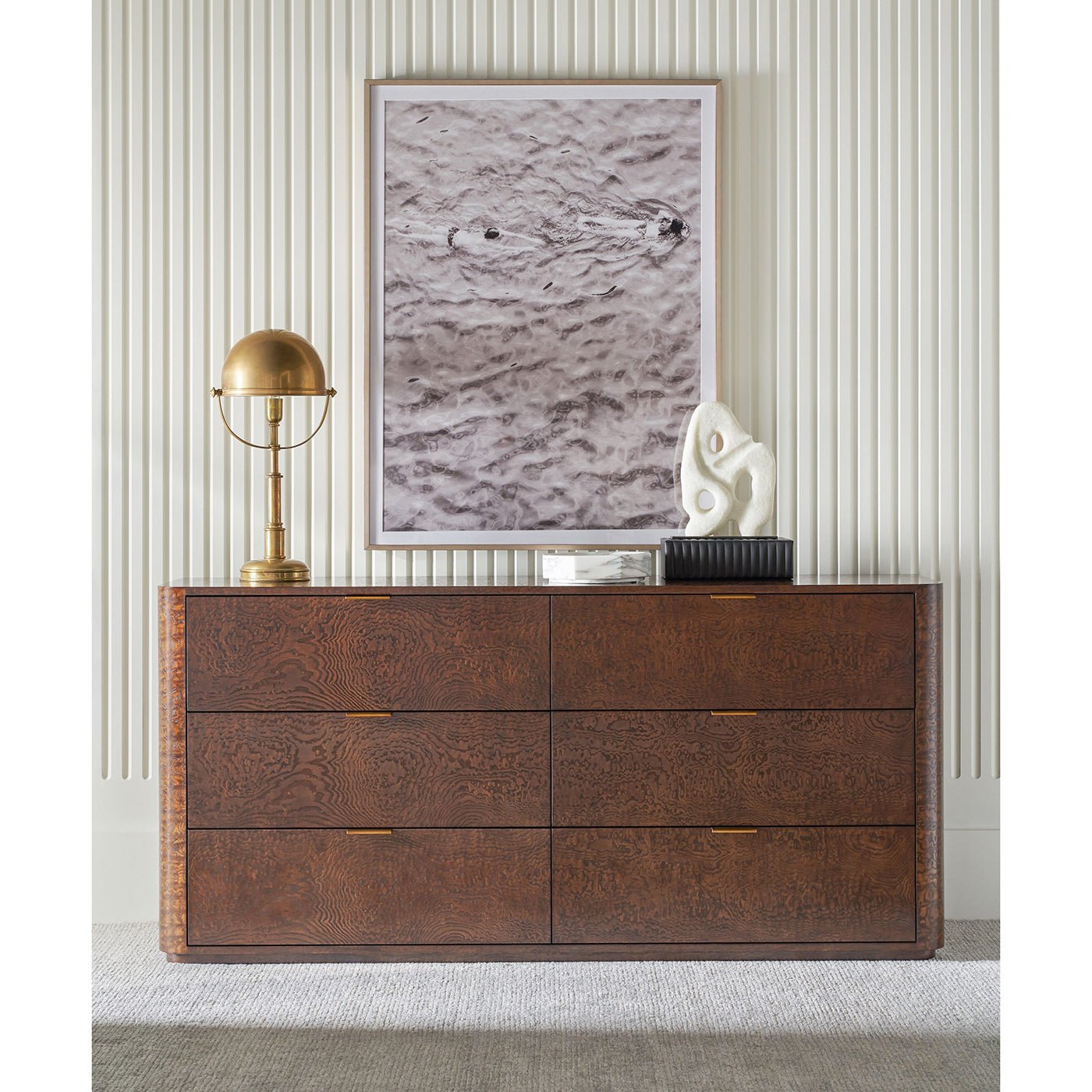Decor styled on six-drawer dresser with artwork above.
