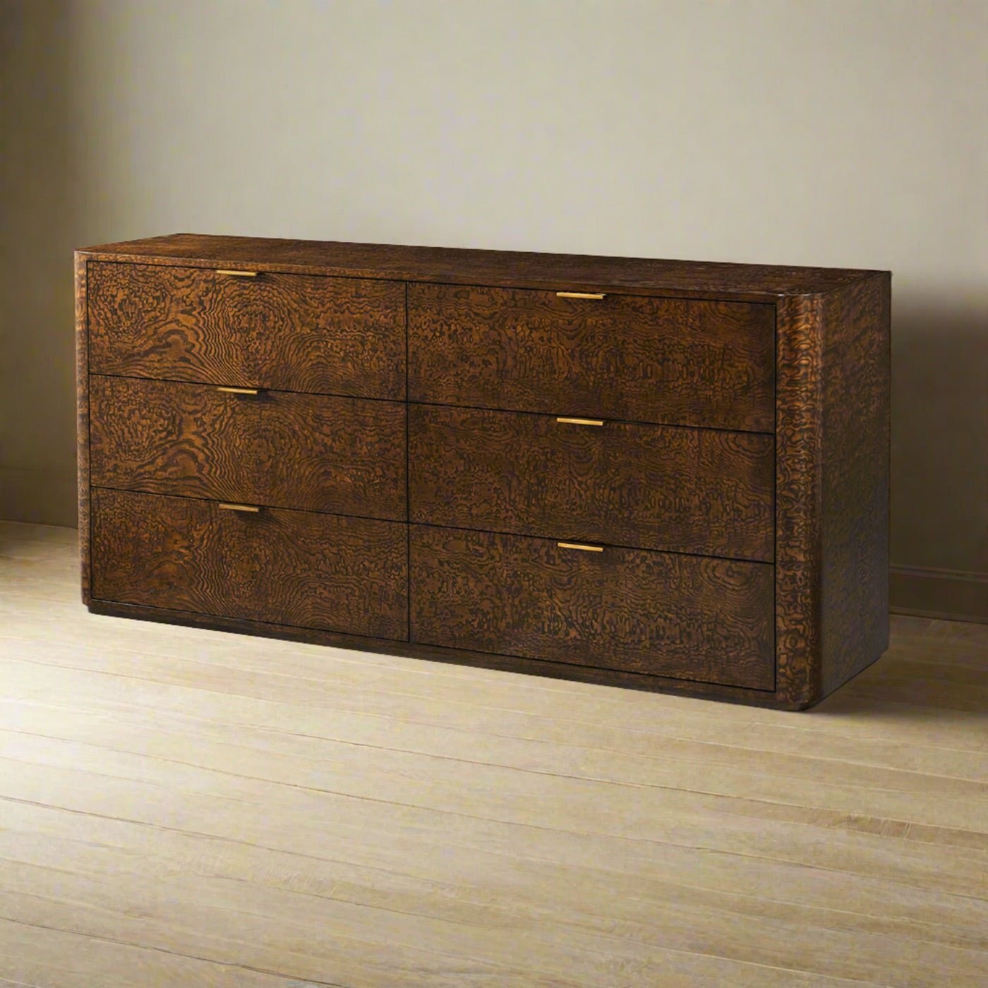 Wooden dresser with six drawers in room setting.