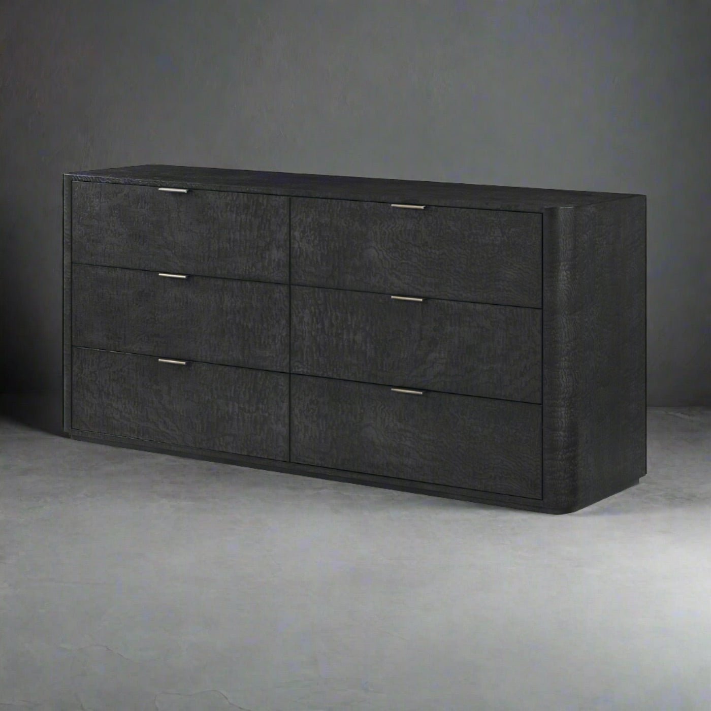 Black art deco dresser with six drawers on gray background.