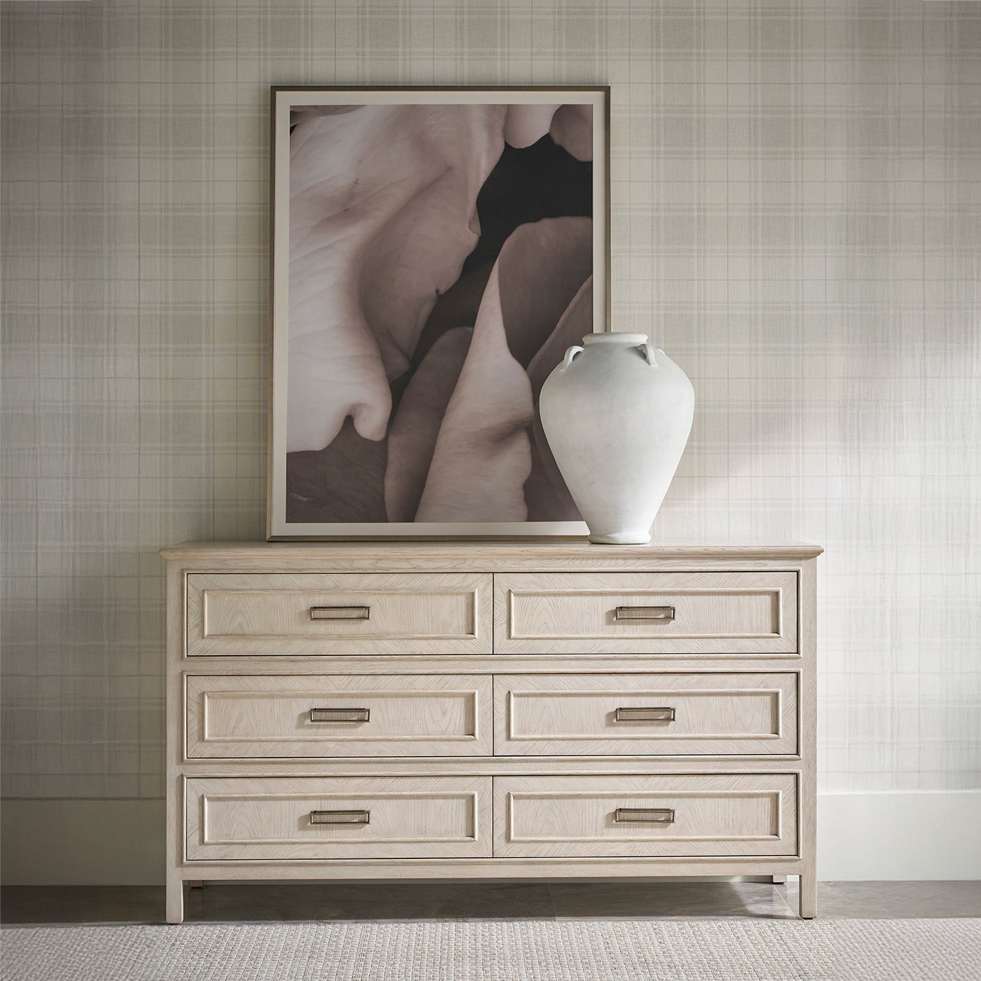 Styled white oak dresser with art and vase on top.
