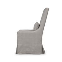 Slipcovered dining chair side profile view with cushion.
