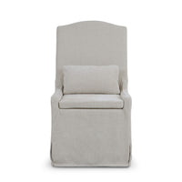 Straight-on slipcovered dining chair, light beige upholstery.