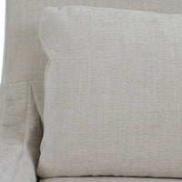Cushion detail slipcovered dining chair, light beige upholstery.