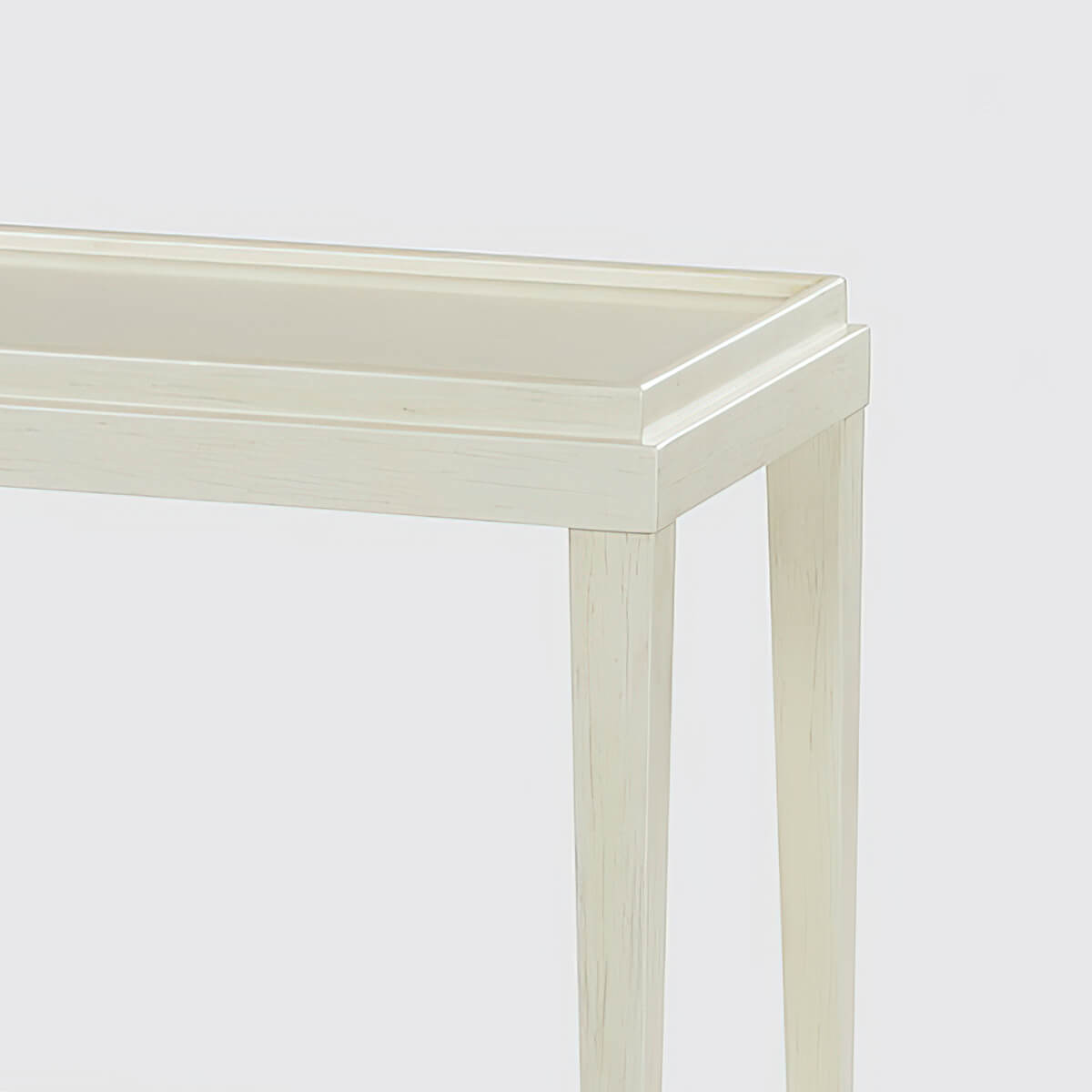 Close-up of table corner, drift white finish.