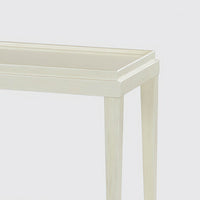 Close-up of table corner, drift white finish.