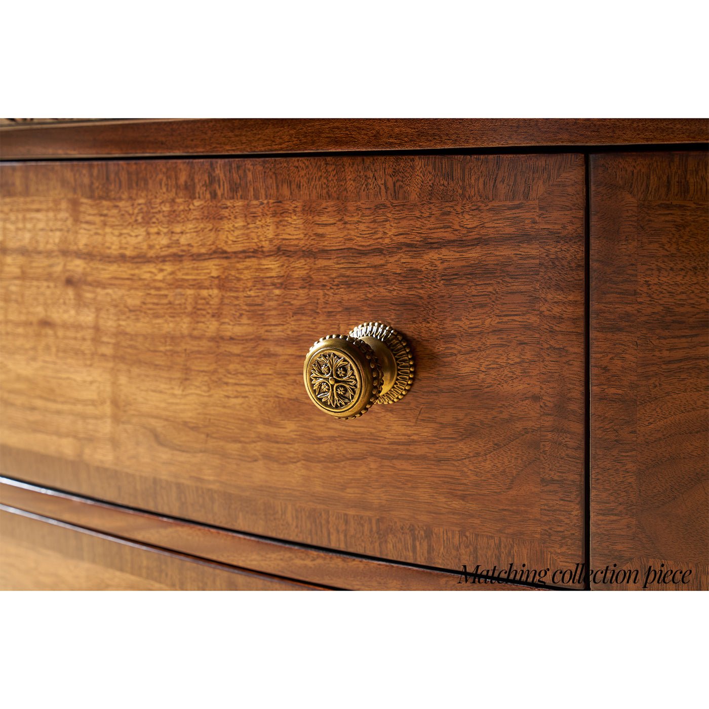 Detailed brass knob on wooden nightstand drawer, close-up.