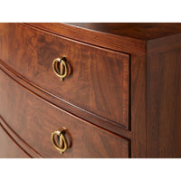 Close-up of walnut chest of drawers detail, gold handles.
