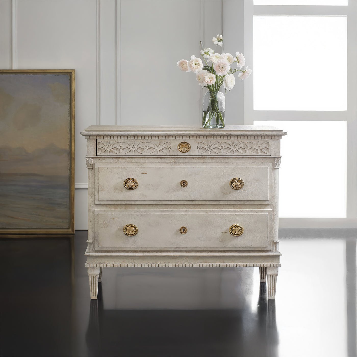 Gustavian bedside chest with flowers on top, room setting.