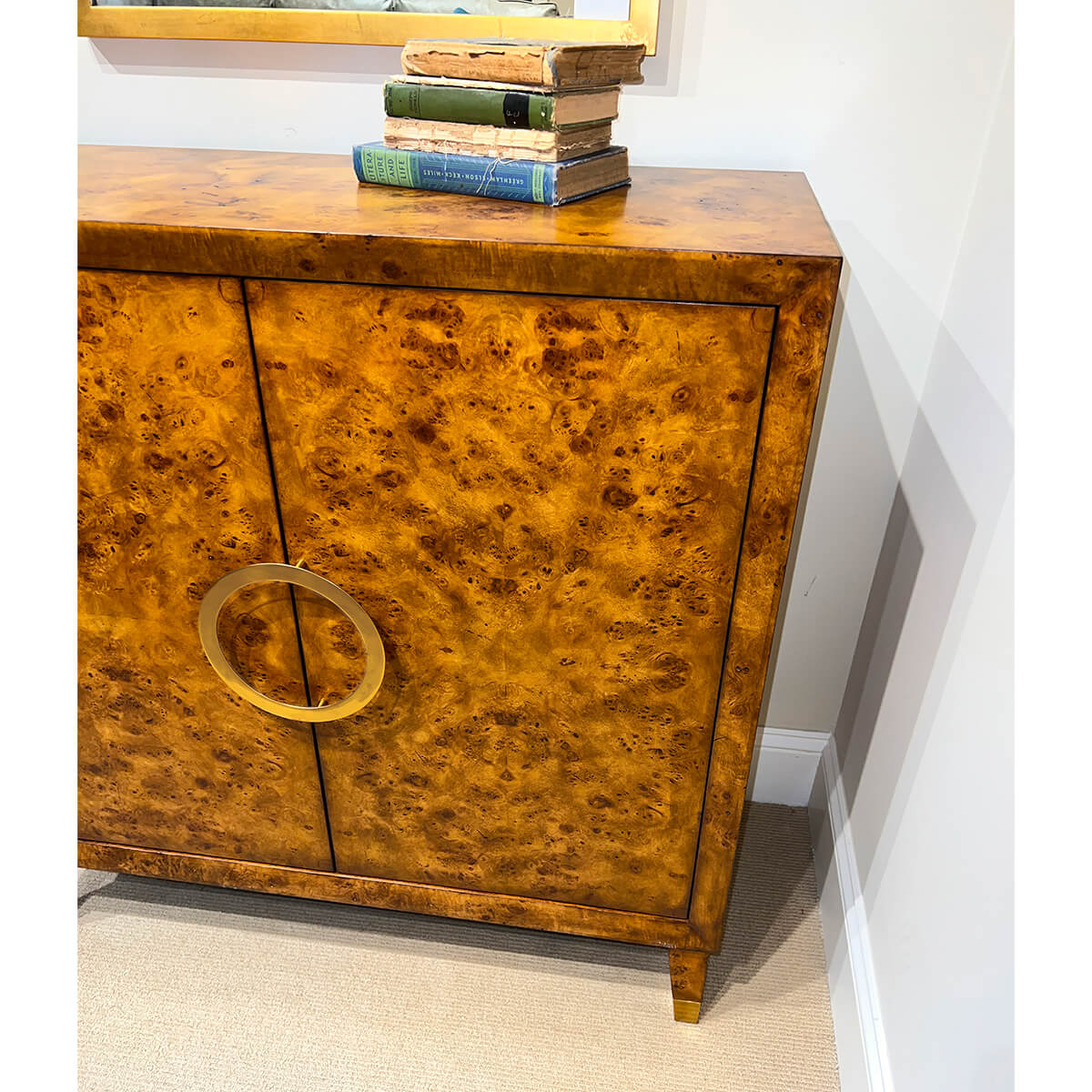 Small Mid-Century Burl Cabinet with books on top.