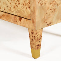 Burl cabinet leg with brass accent close-up.