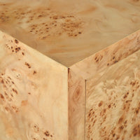 Close-up of light burl cabinet corner.