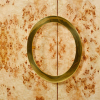 Circular handle detail on burl cabinet doors.