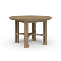 Round wood dining table, angled view.