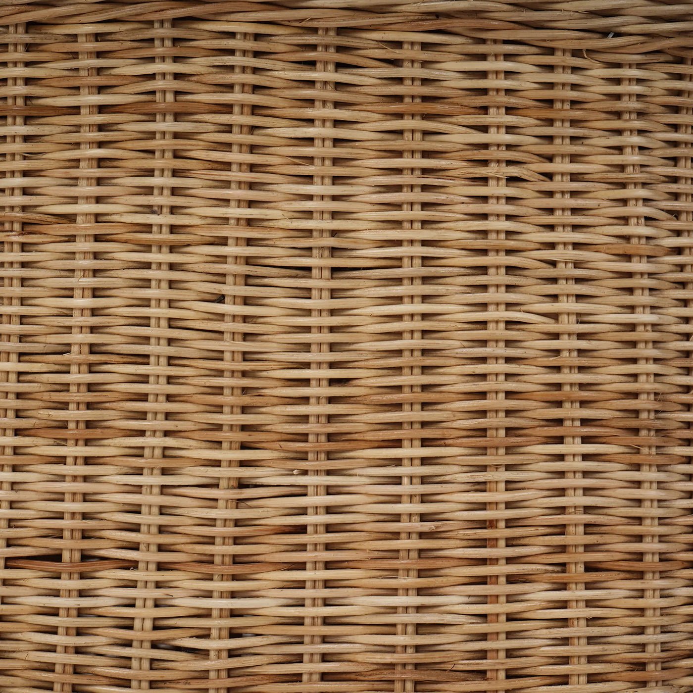 Detailed view of woven rattan material on ottoman.