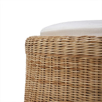 Close-up of rattan ottoman texture and cushion detail.