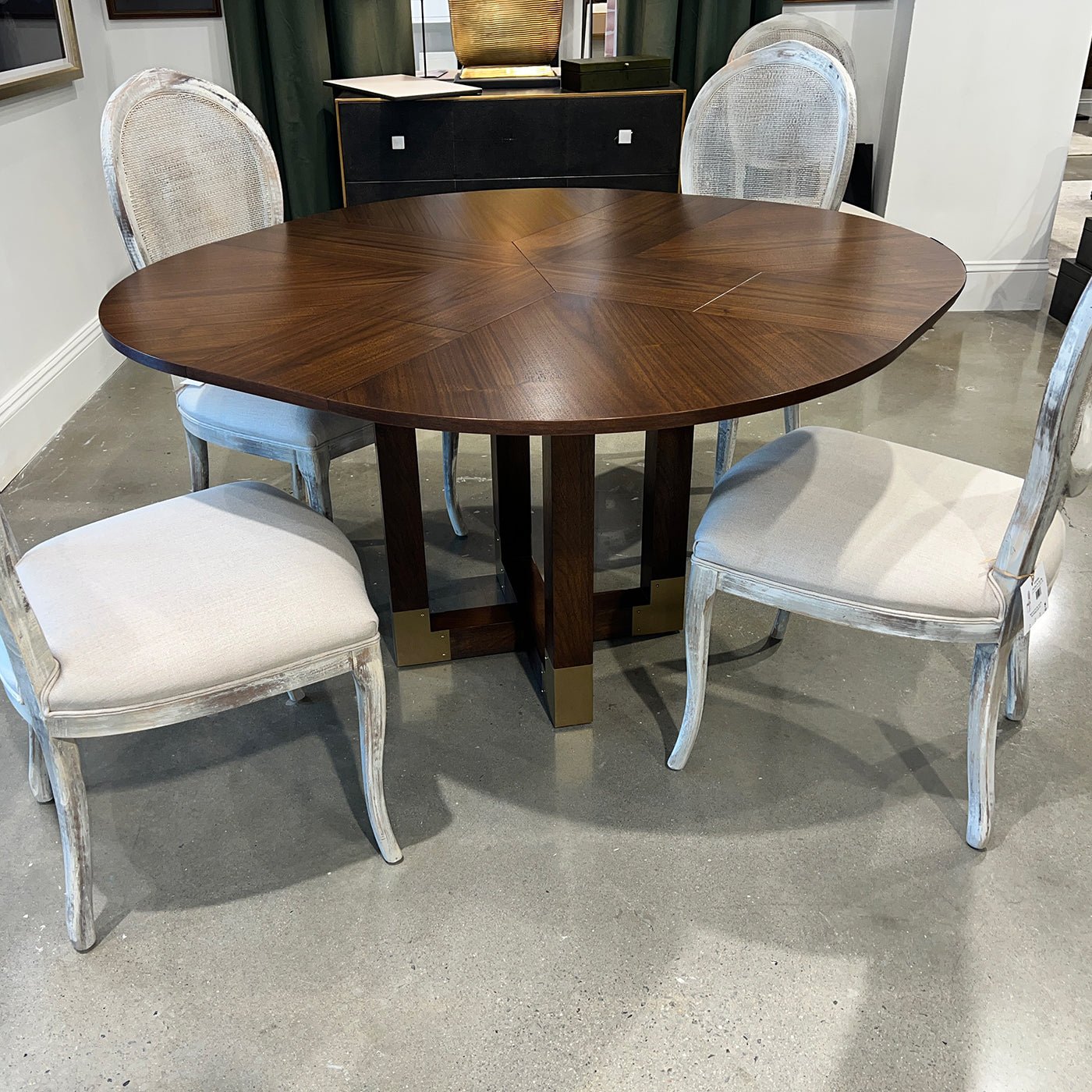 Table with four chairs in showroom setting.