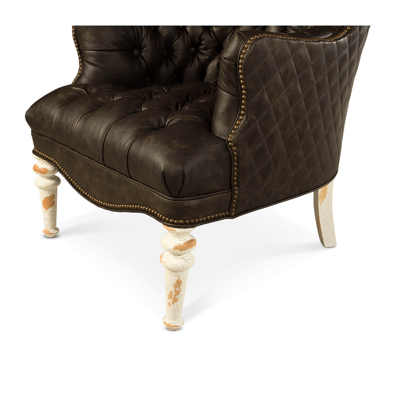 Tufted leather accent chair, distressed white wooden legs detail.