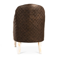 Dark brown tufted leather accent chair, back quilted view.