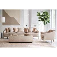 Coffee table with neutral sofa and armchair arrangement.