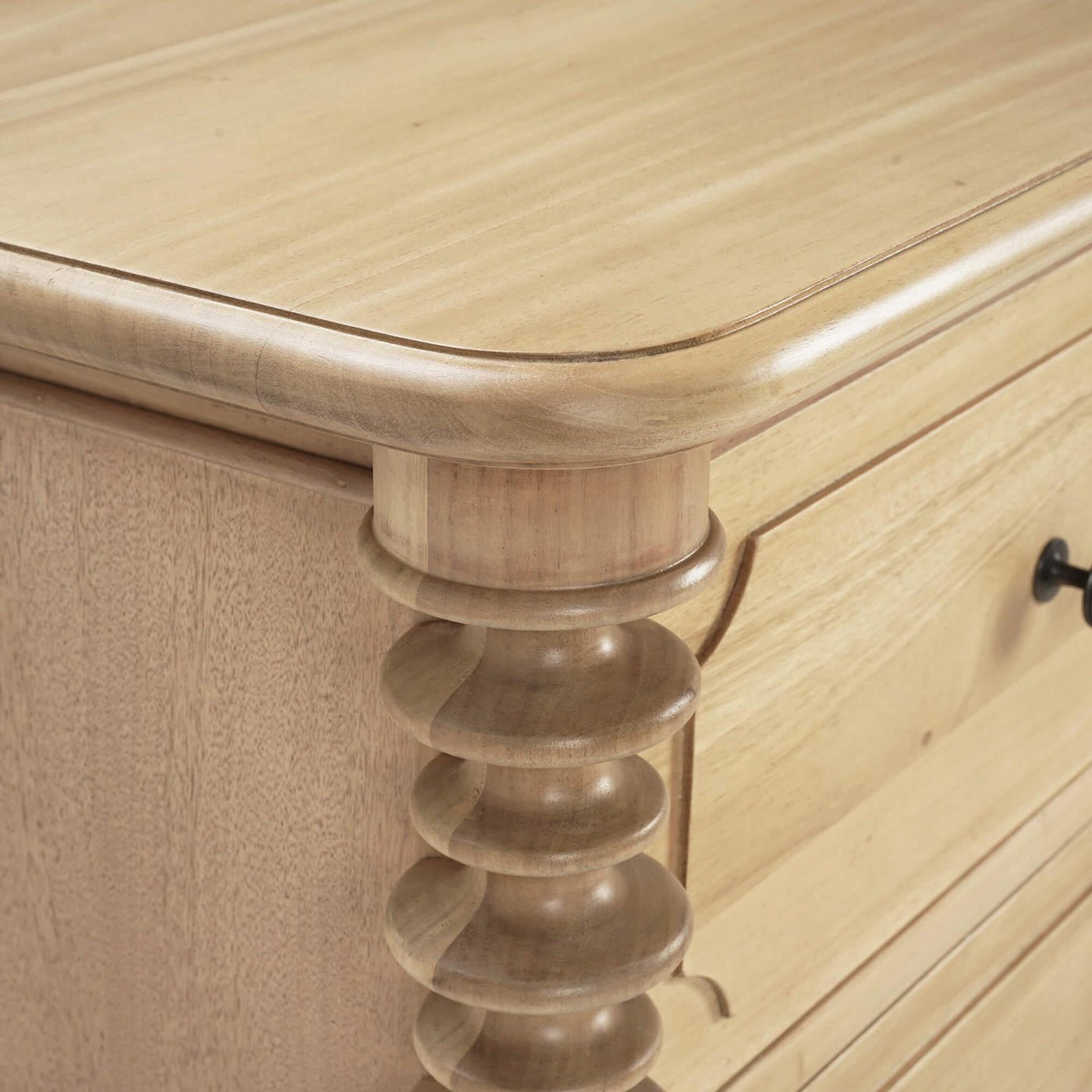 Detailed view of dresser corner and top edge.