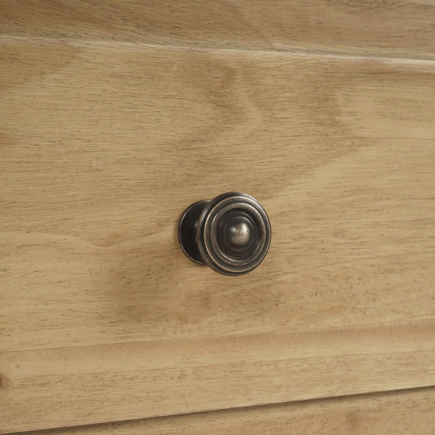 Close-up of spool-turned chest drawer knob.