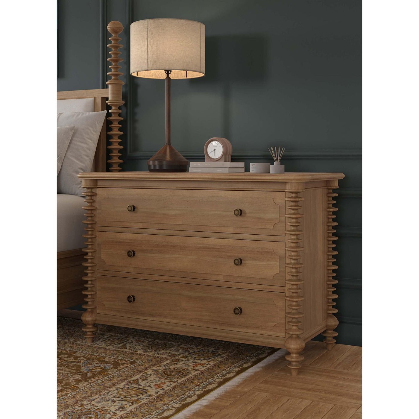 Spool-turned chest in bedroom setting with lamp.