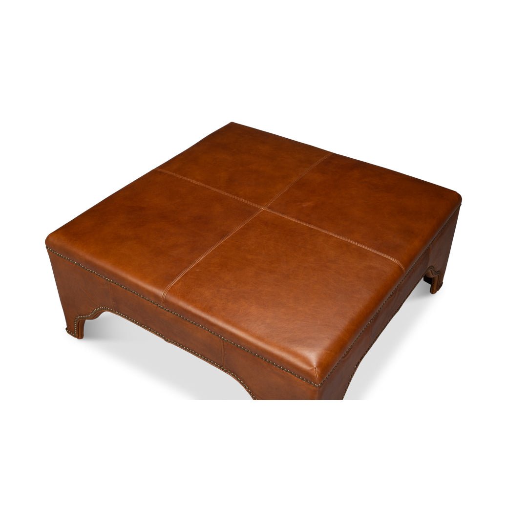 Top view of square brown leather ottoman.