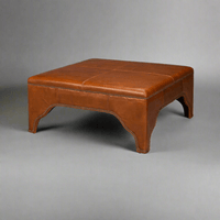 Square brown leather ottoman, plain background, angled view.
