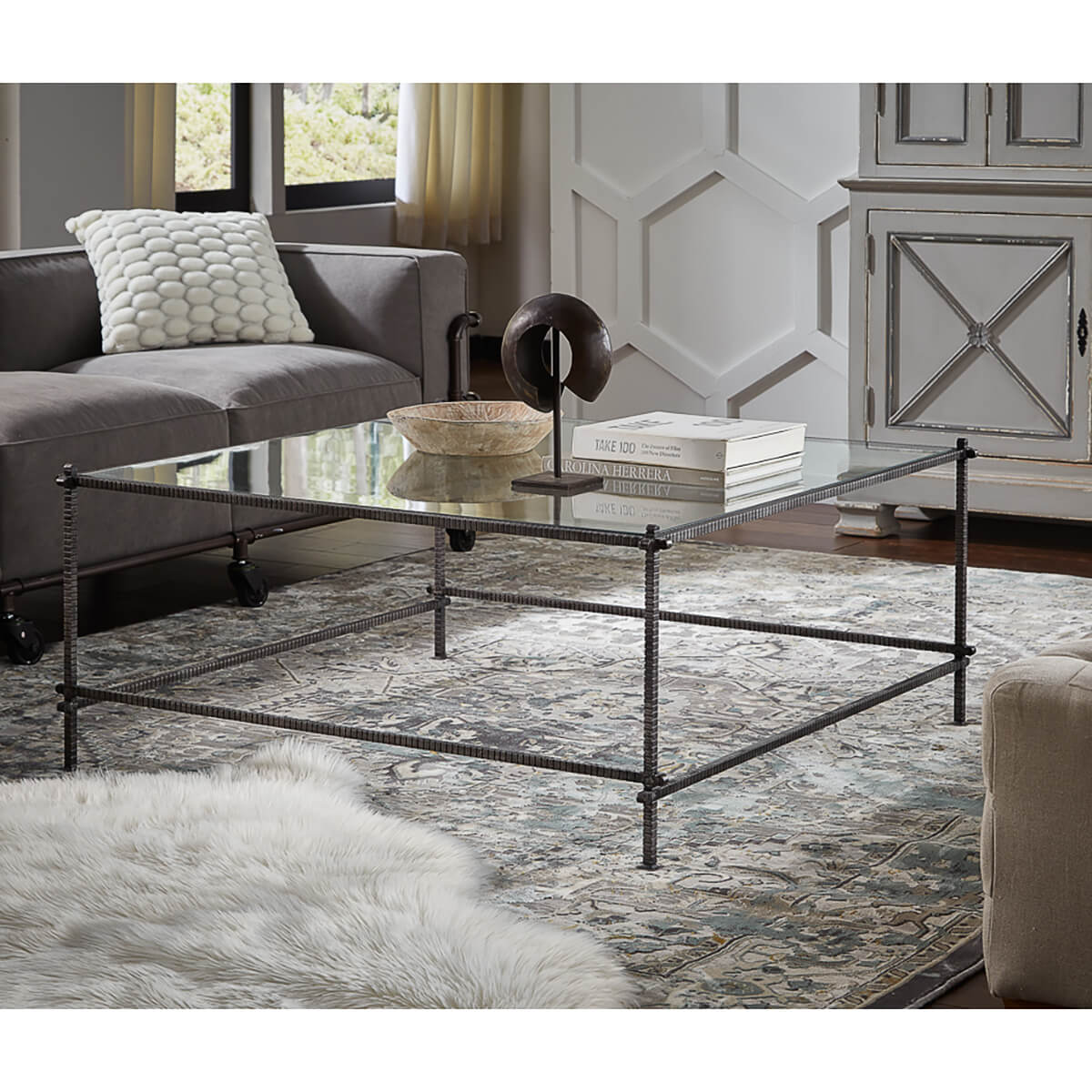 Industrial table in room setting, books and decor items.