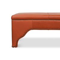 Close-up side detail of the ottoman's leg.