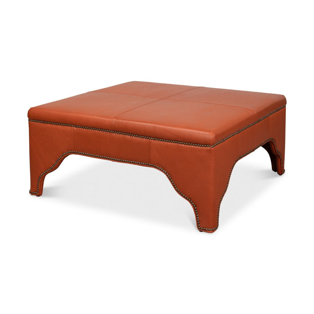 Square leather cocktail ottoman, angled view.