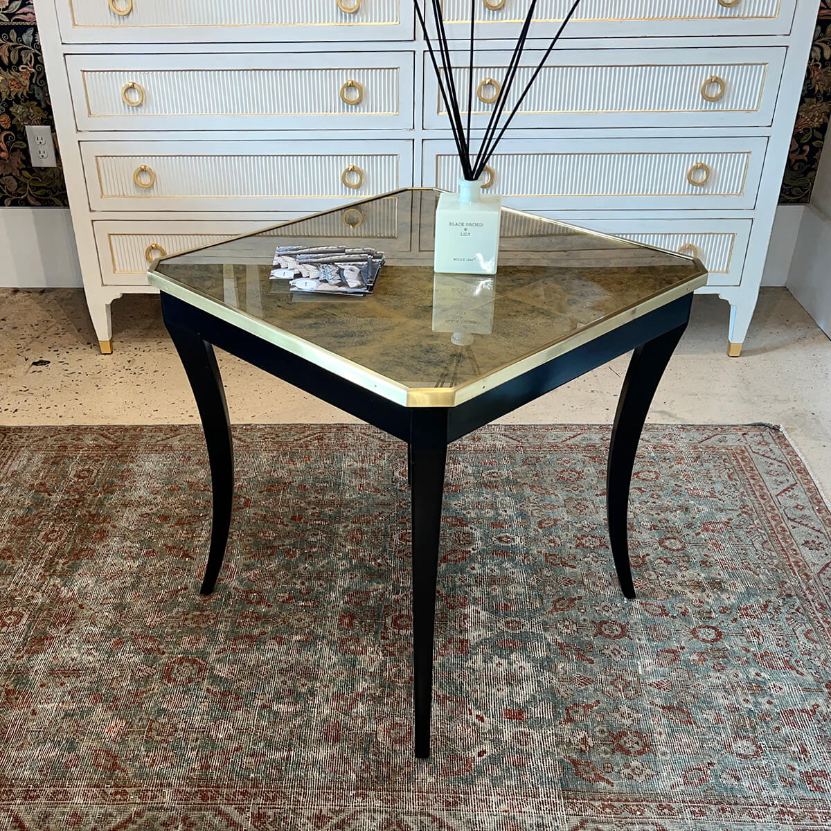 Antique-style end table with gold detailing and decor.