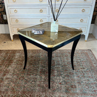 Antique-style end table with gold detailing and decor.