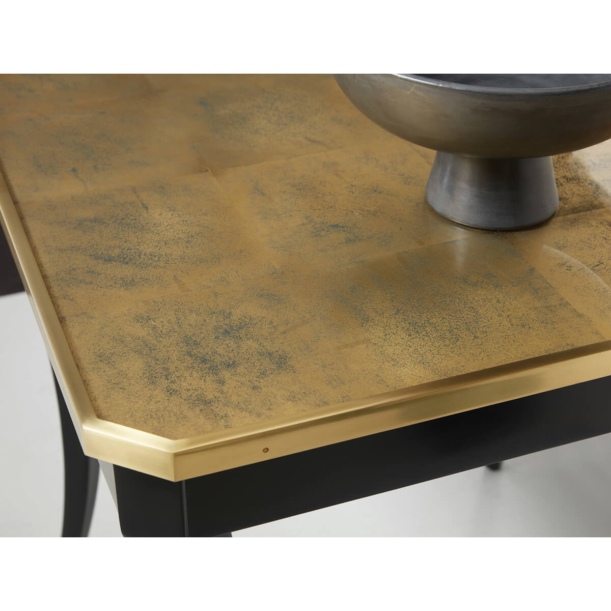 Close-up of table's gold-finished wooden top.