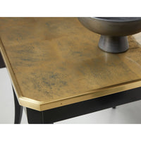 Close-up of table's gold-finished wooden top.