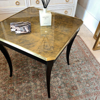 Decorated square end table with gold top.