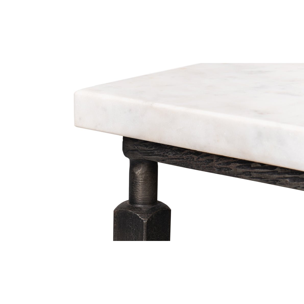 Close-up of marble tabletop and metal frame joint.