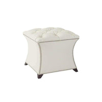 White square tufted stool with decorative nailhead trim.