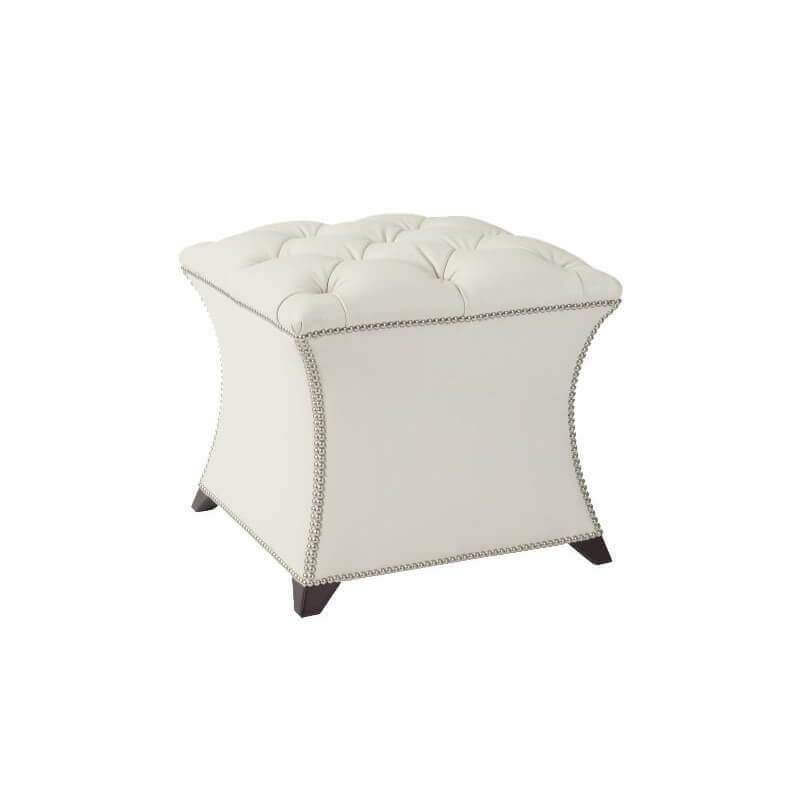 White square tufted stool with decorative nailhead trim.