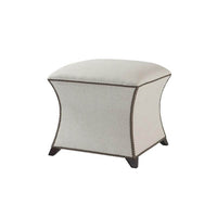 Beige square upholstered stool with decorative trim, angled view.