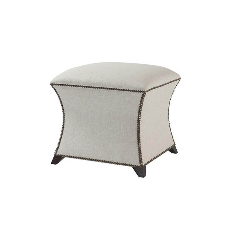 Beige square upholstered stool with decorative trim, angled view.