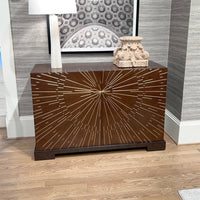 Starburst art deco cabinet with decor and lamp.